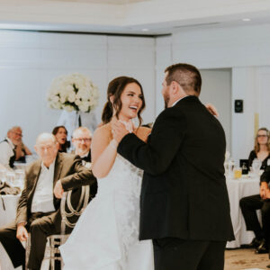 A joyful couple celebrates on the dance floor as The Todd Everett Experience spins a perfect reception soundtrack.